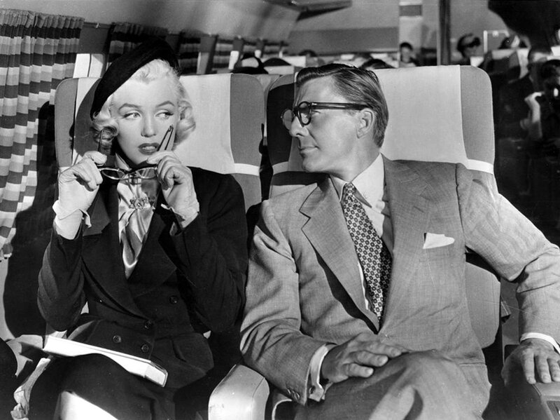 Marilyn Monroe and a man on an airplane
