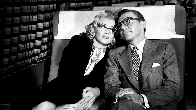 Marilyn Monroe and a man on an airplane