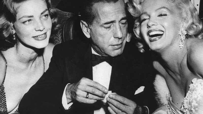 Marilyn Monroe and Lauren Bacall with a man