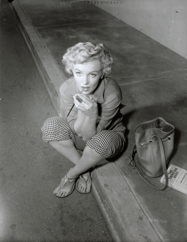 Marilyn Monroe applying lipstick