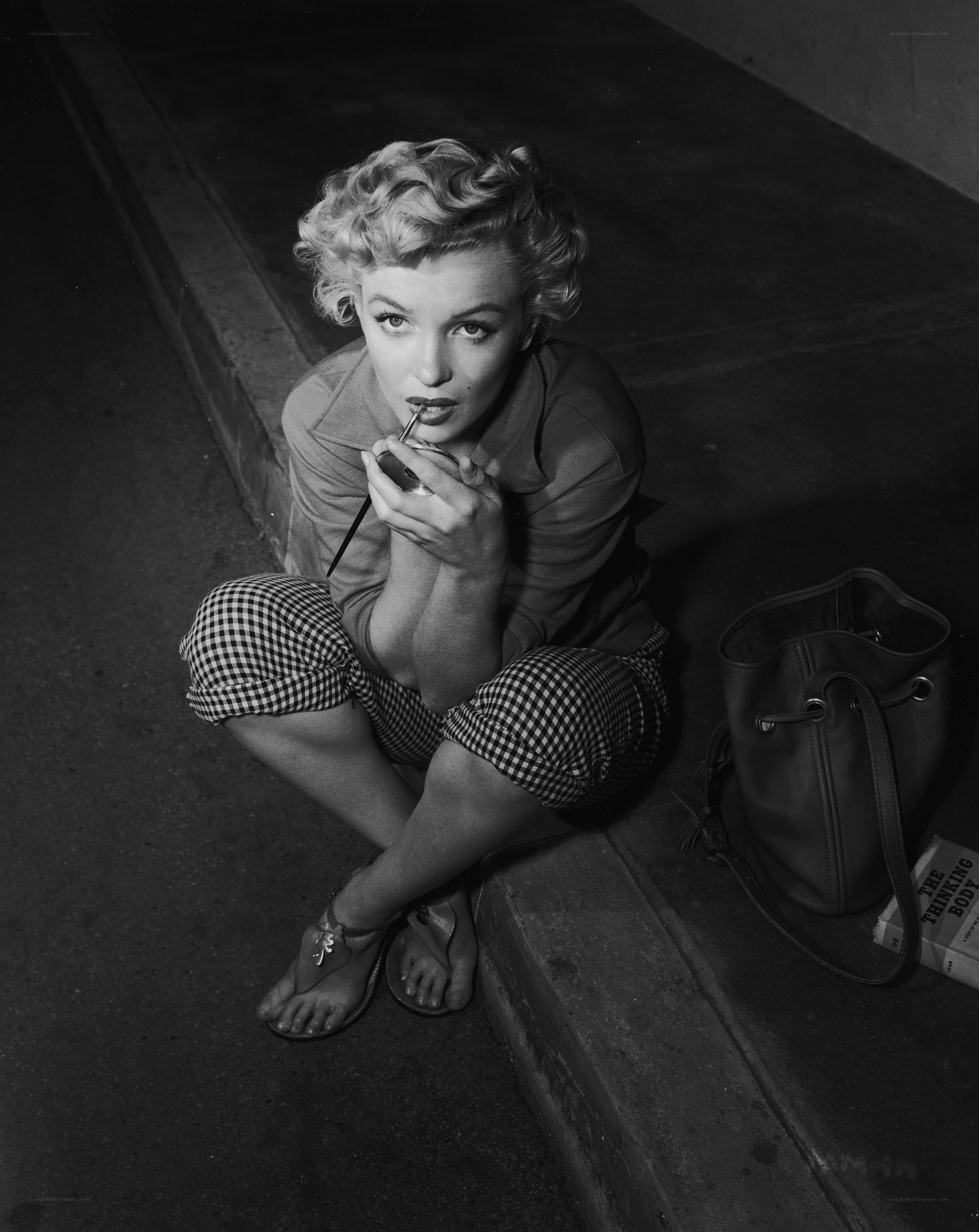 Marilyn Monroe applying lipstick