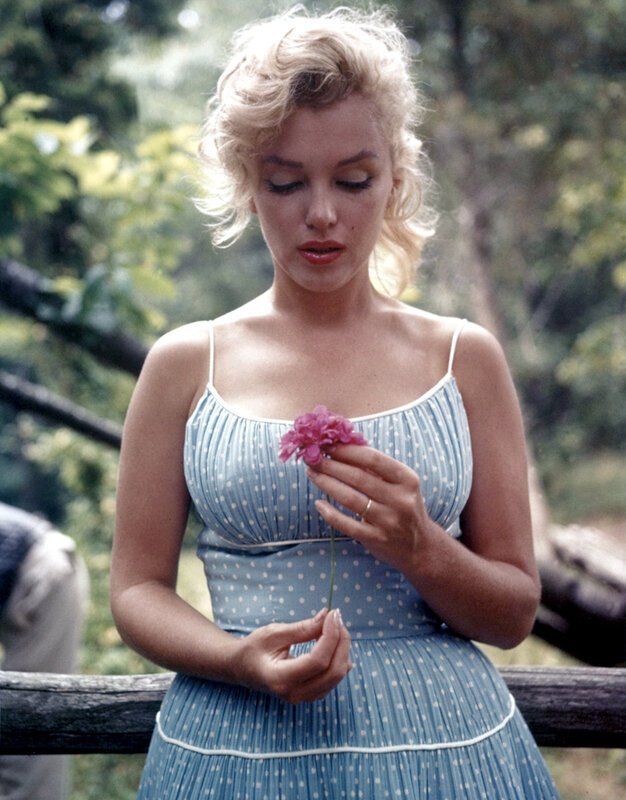 Marilyn Monroe holding a flower