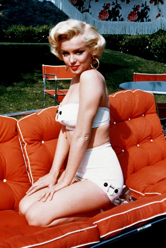 Marilyn Monroe on a red couch