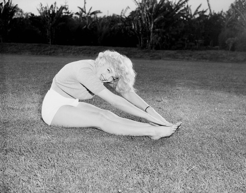 Marilyn Monroe stretching on grass