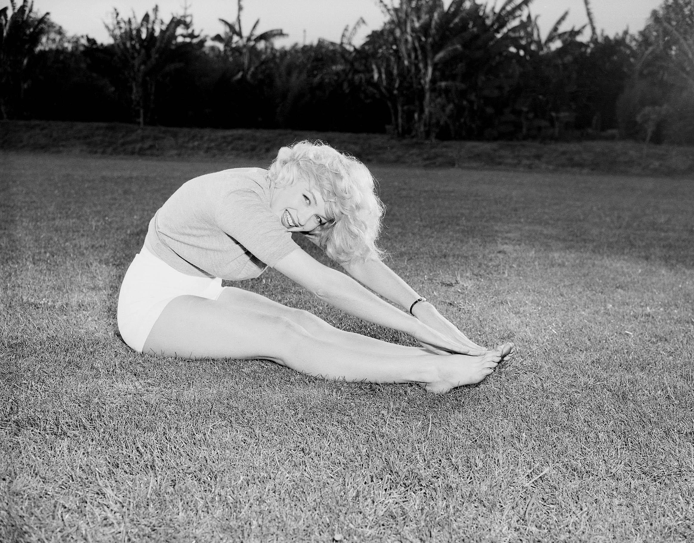 Marilyn Monroe stretching on grass