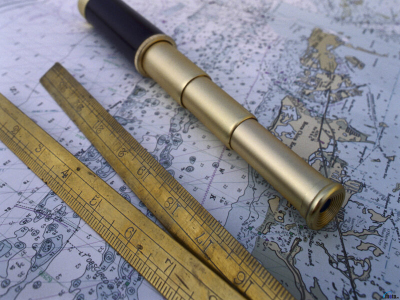 Marine compass and ruler on chart