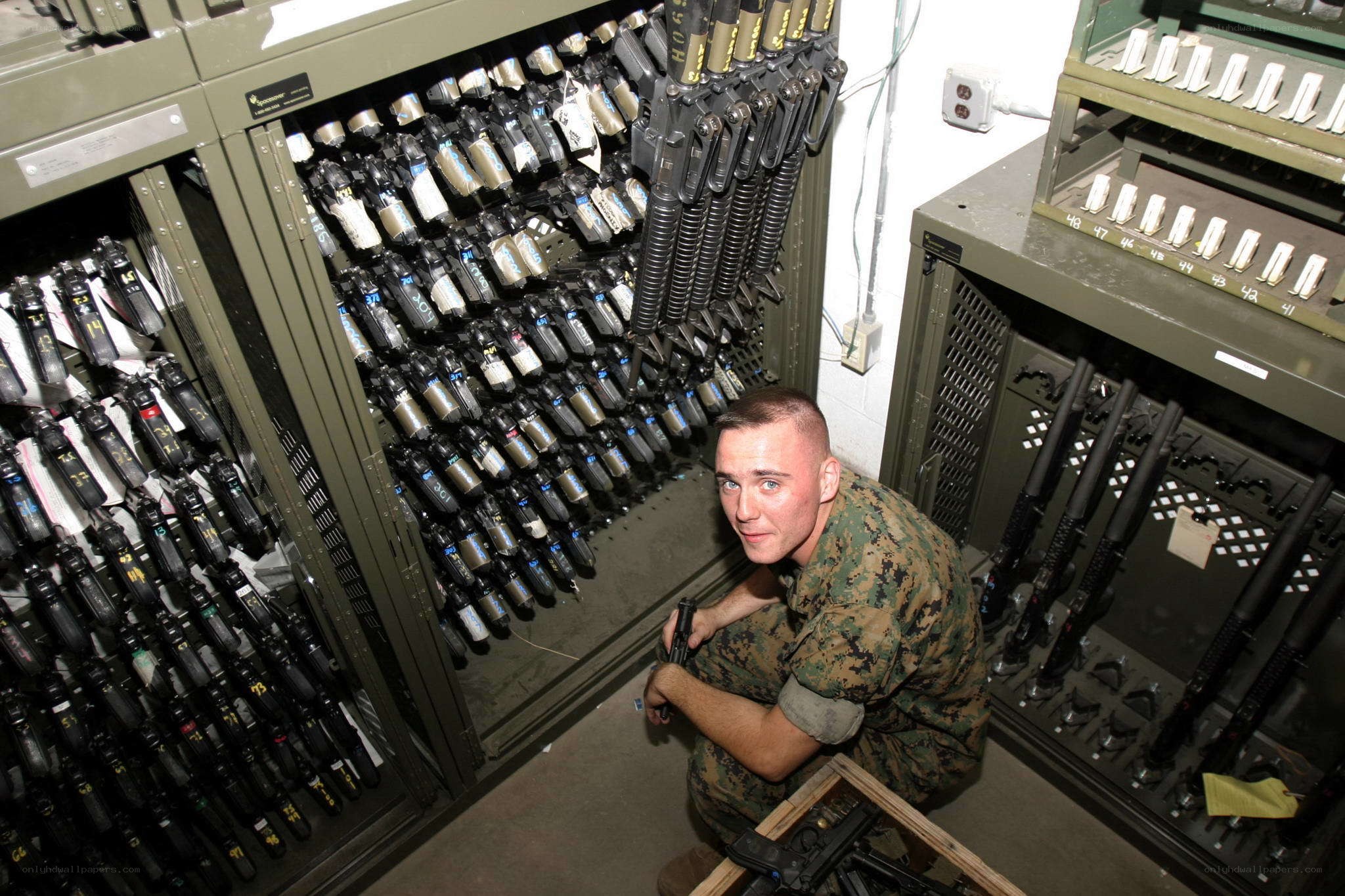 Marine in armory with weapons