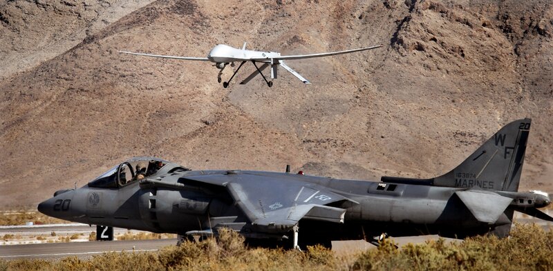 Marine jet and drone on airfield