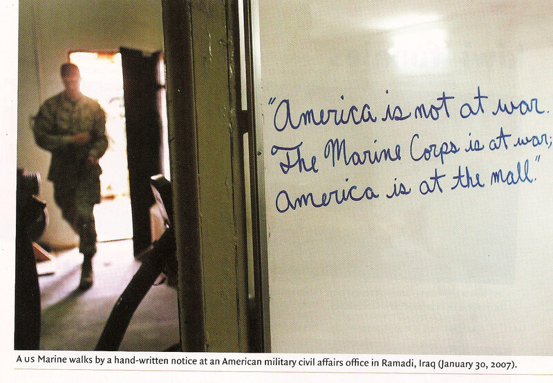 Marine walks past notice in Iraq