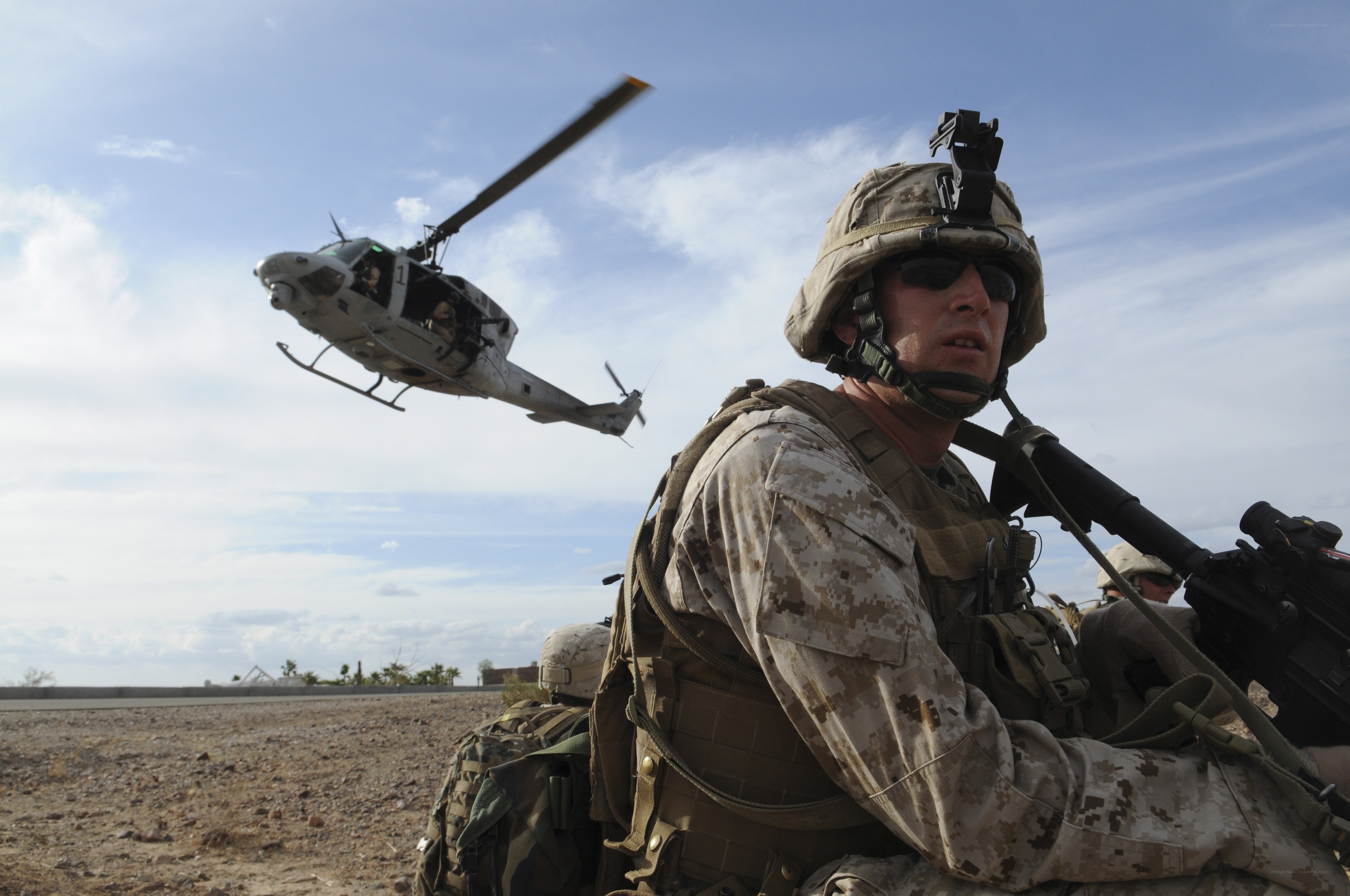 Marine with helicopter in background