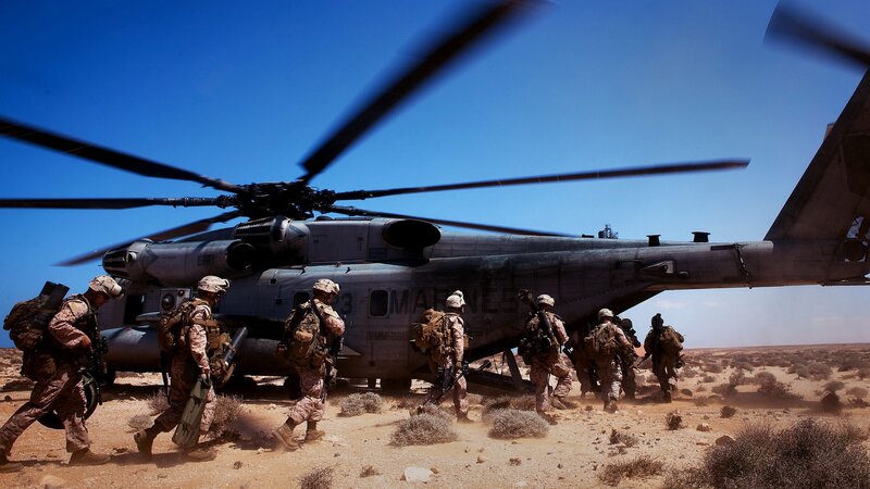Marines boarding helicopter in desert
