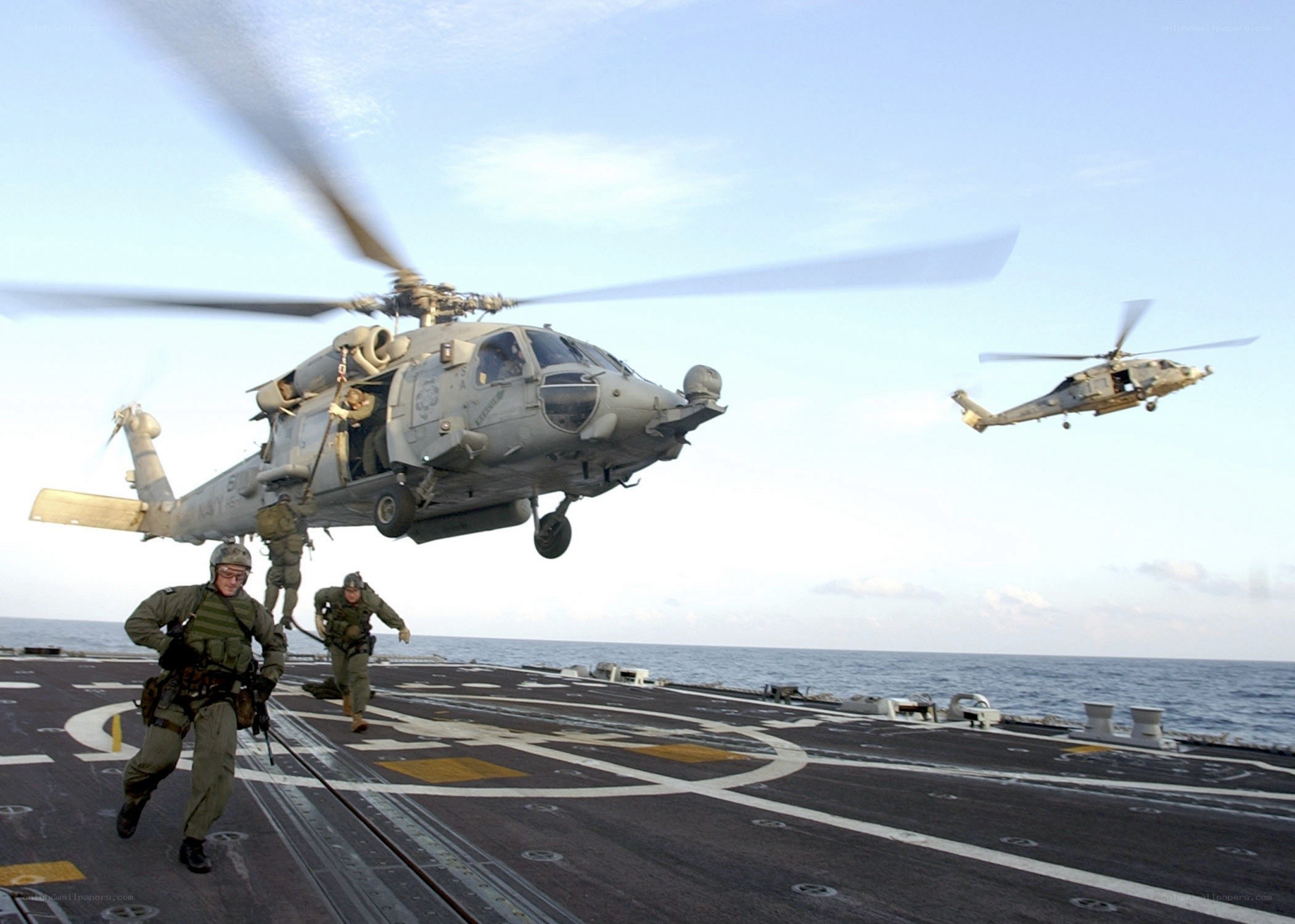 Marines boarding helicopter on ship deck