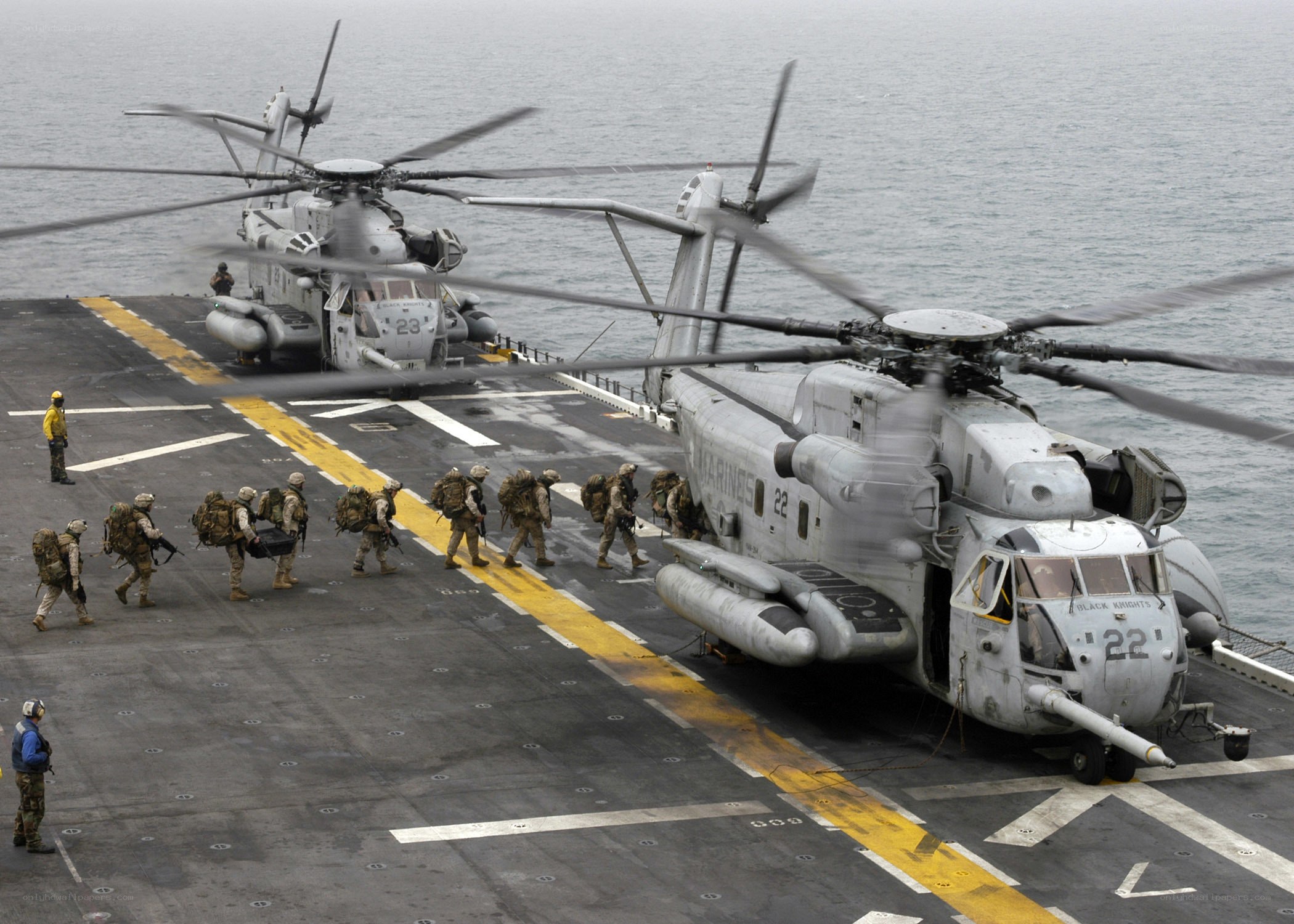 Marines boarding helicopters on ship deck