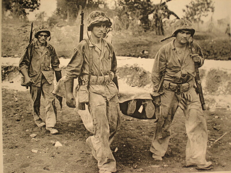 Marines carrying wounded comrade