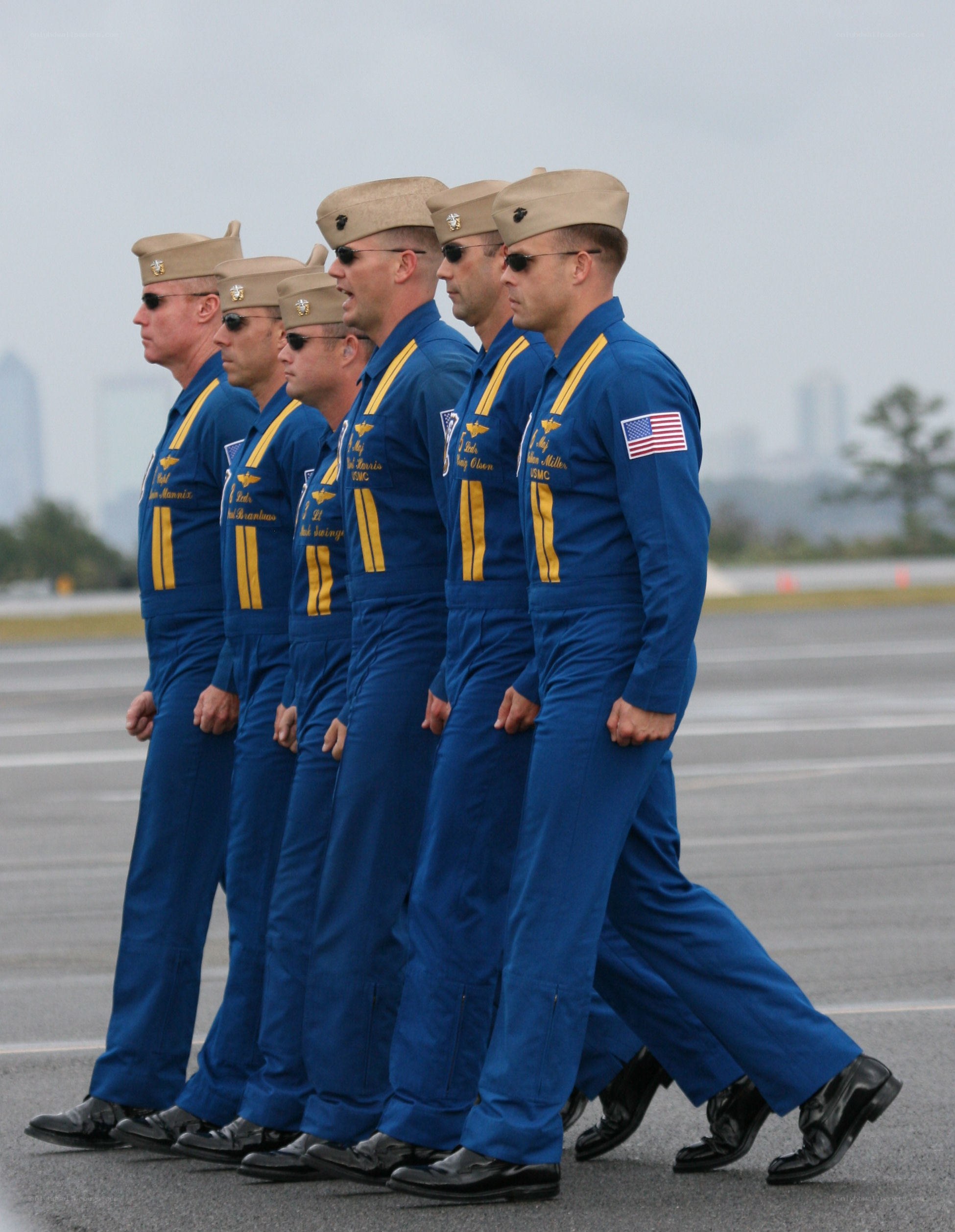 Marines in blue flight suits marching
