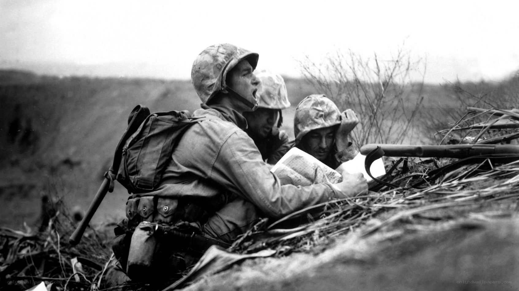 Marines in foxhole during battle