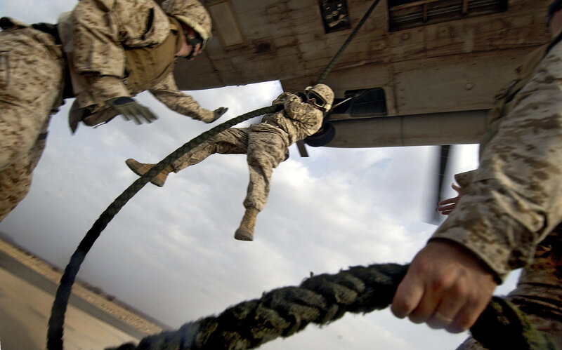 Marines rappelling from helicopter