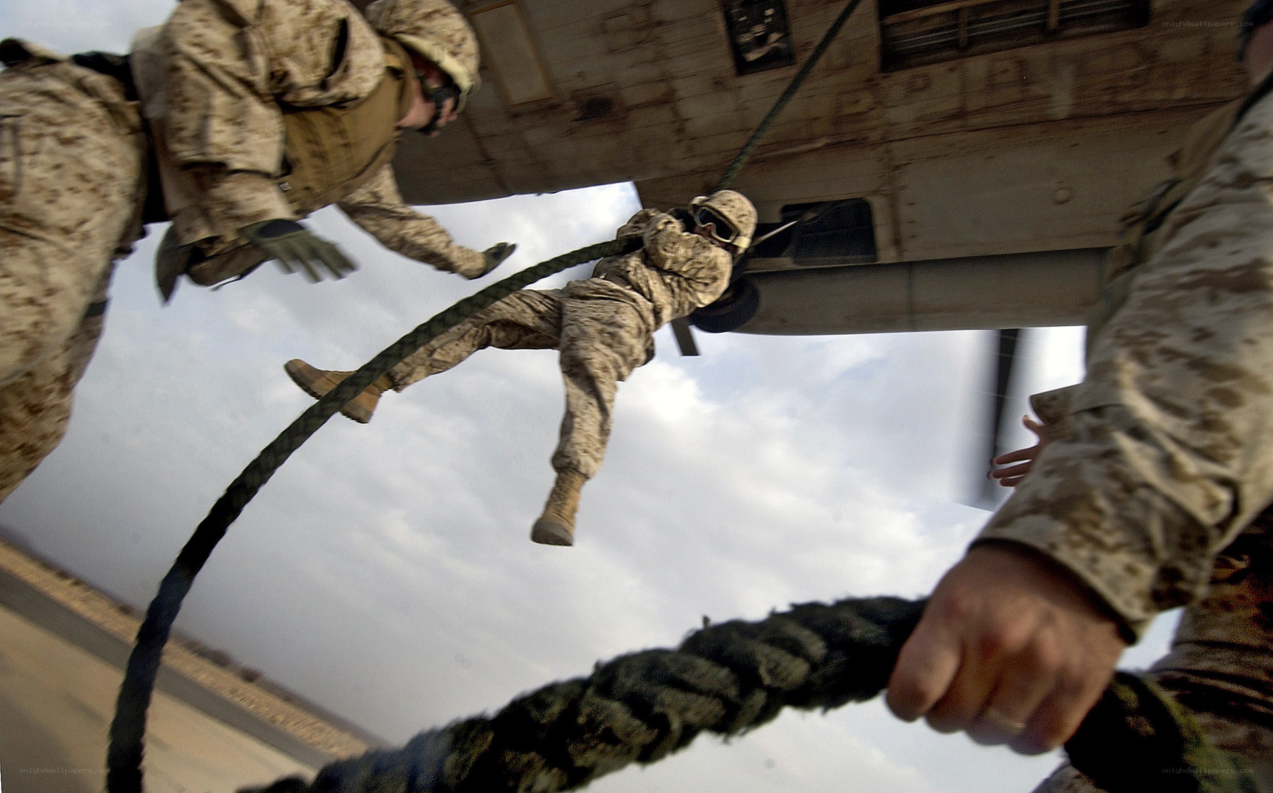 Marines rappelling from helicopter