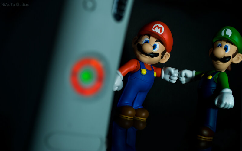 Mario and Luigi figurines with controller
