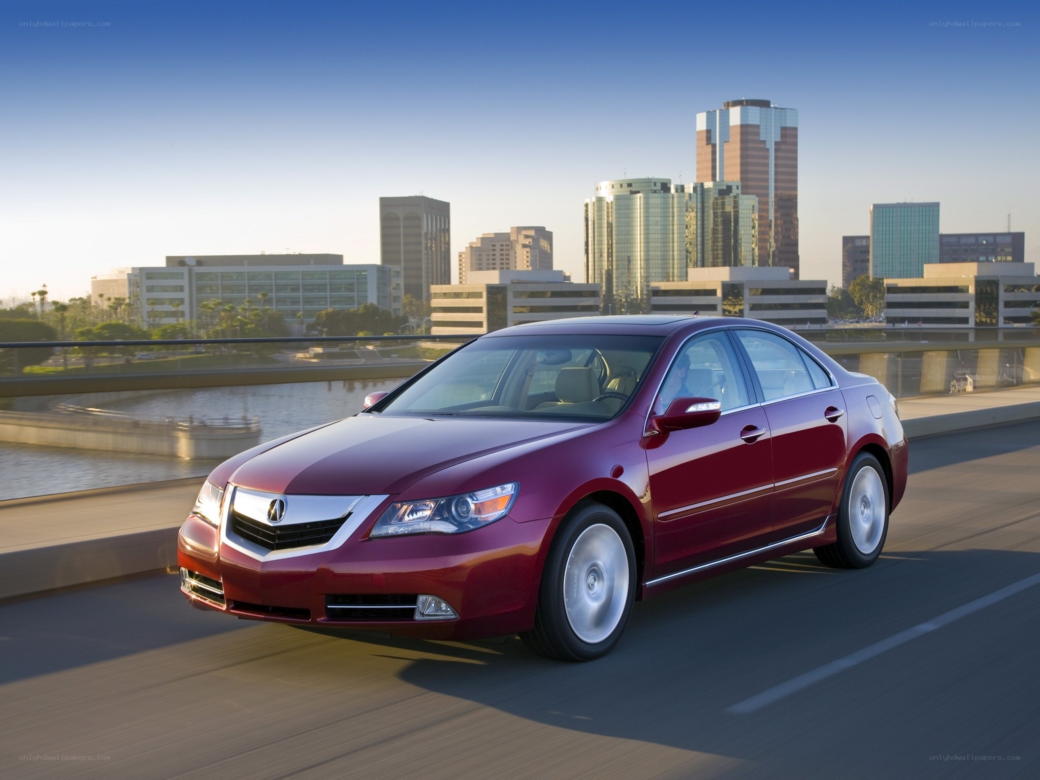 Maroon Acura driving on bridge