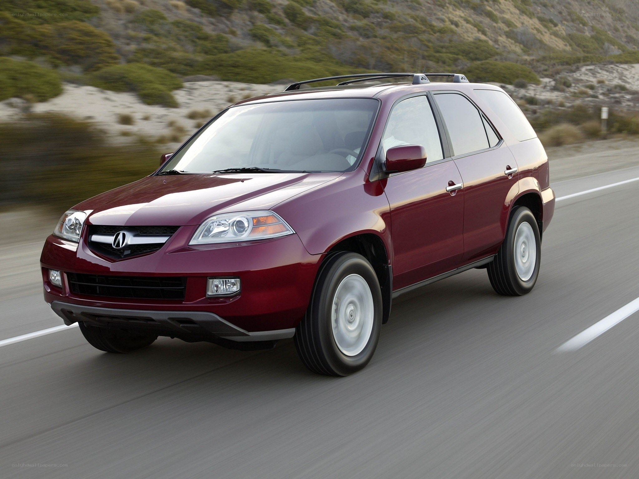 Maroon Acura MDX driving on road