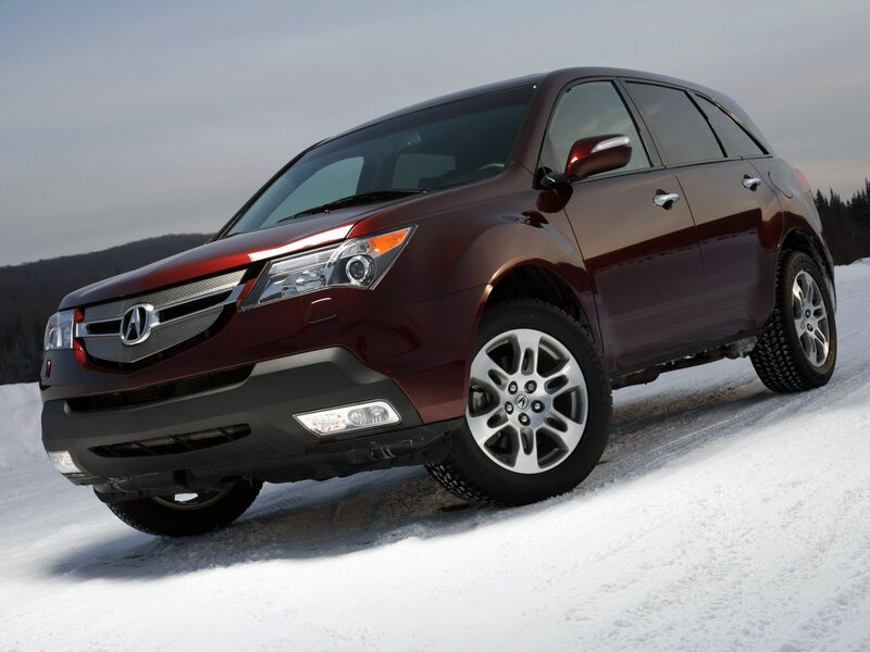Maroon Acura MDX on snowy terrain