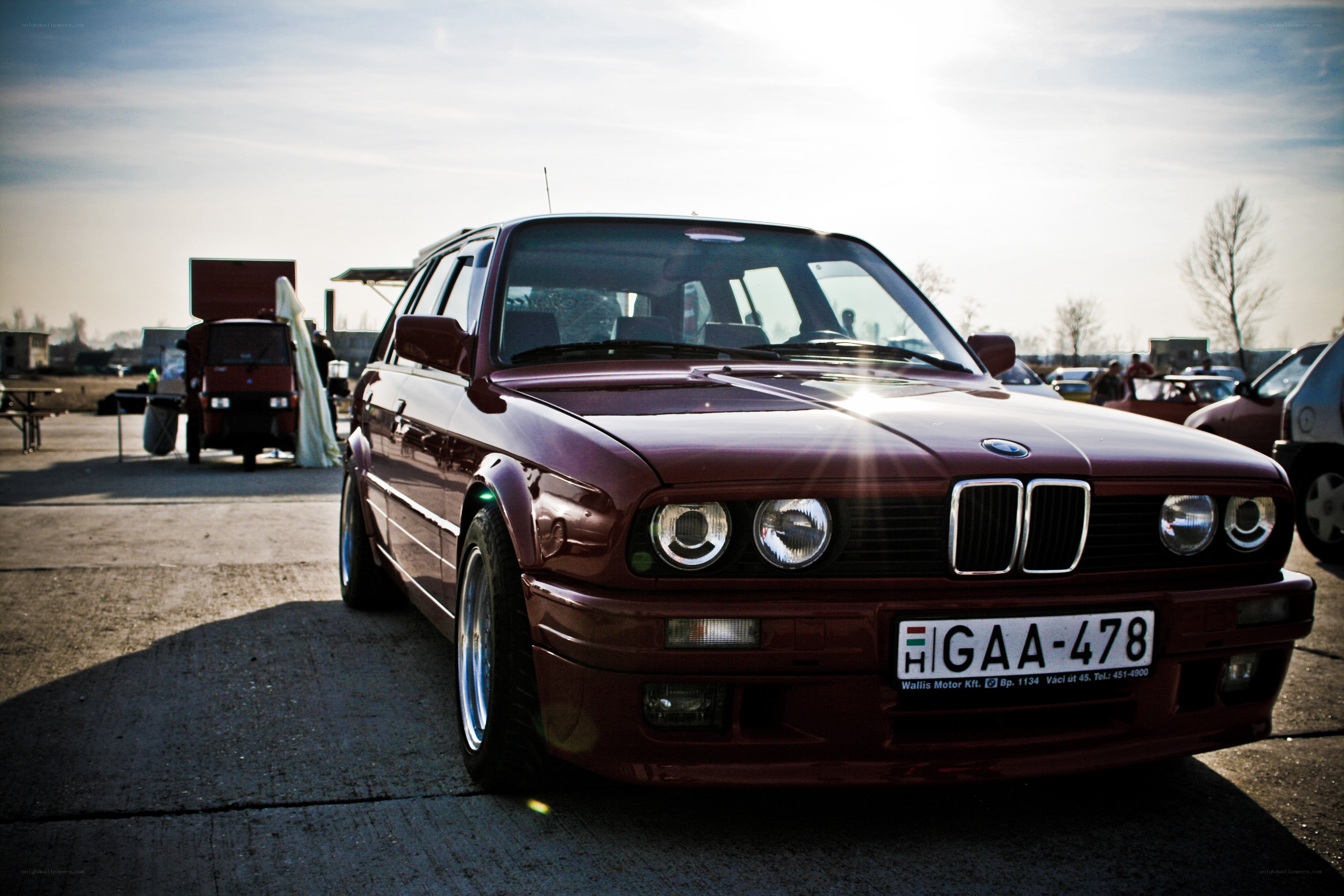 Maroon BMW at outdoor event