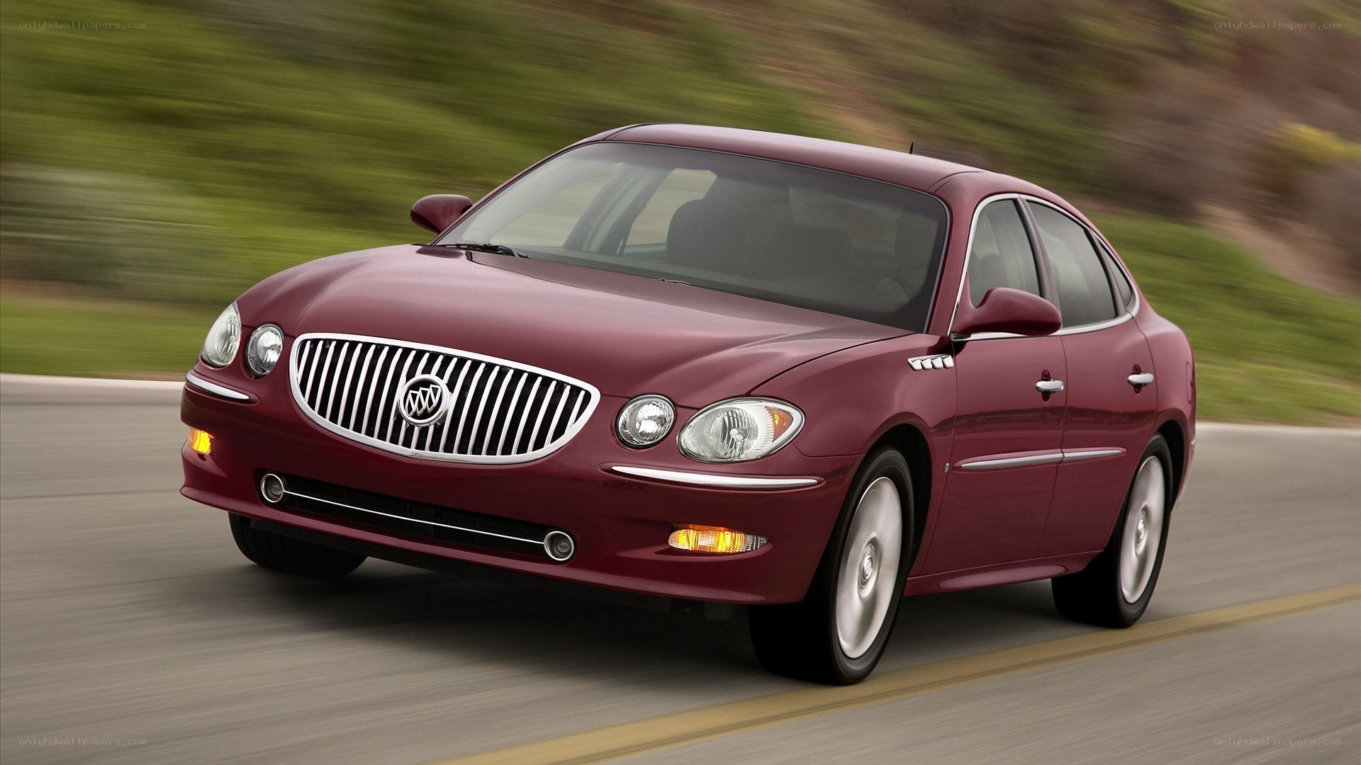 maroon buick sedan in motion