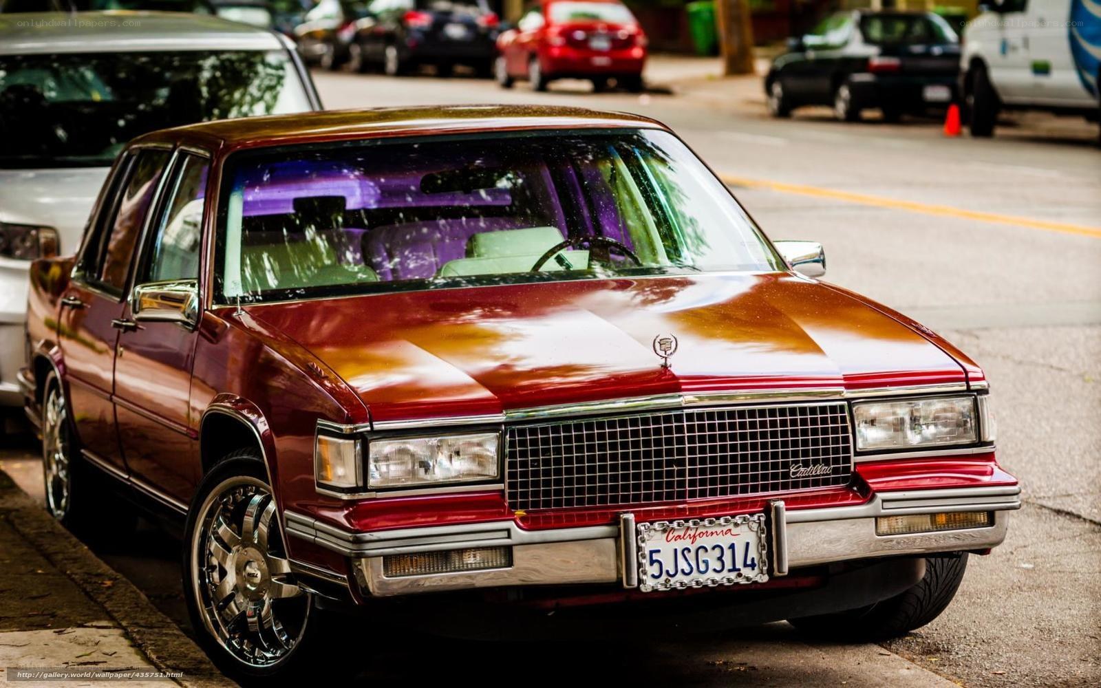 Maroon Cadillac parked on street