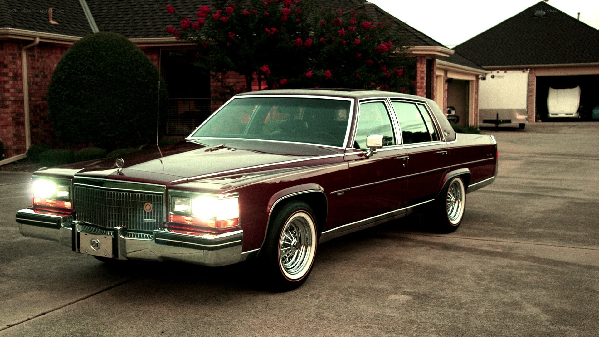 maroon cadillac sedan in driveway