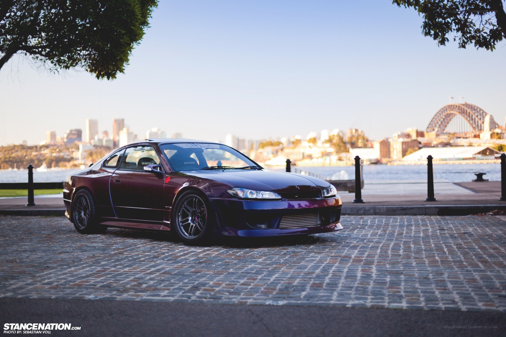 Maroon car by the harbor