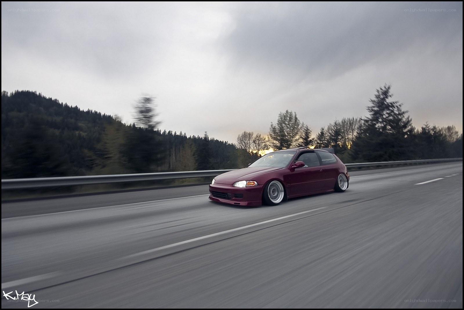 Maroon car on a highway