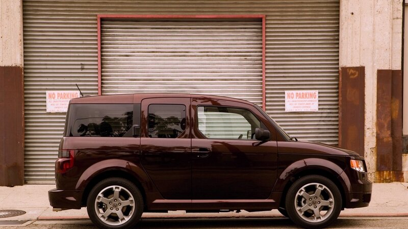 Maroon car parked in front of garage