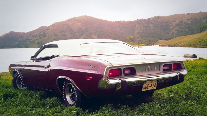 Maroon classic car by the lake