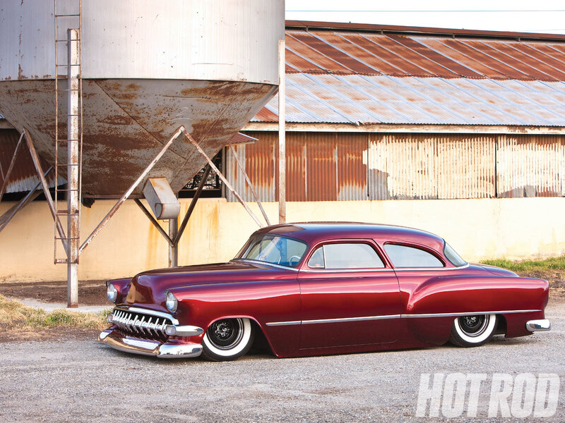 Maroon classic car in industrial setting