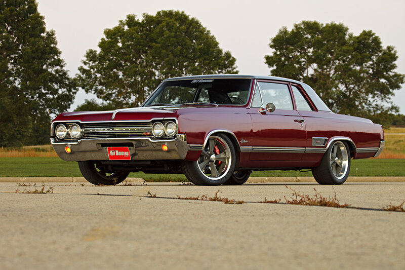 maroon classic car on pavement