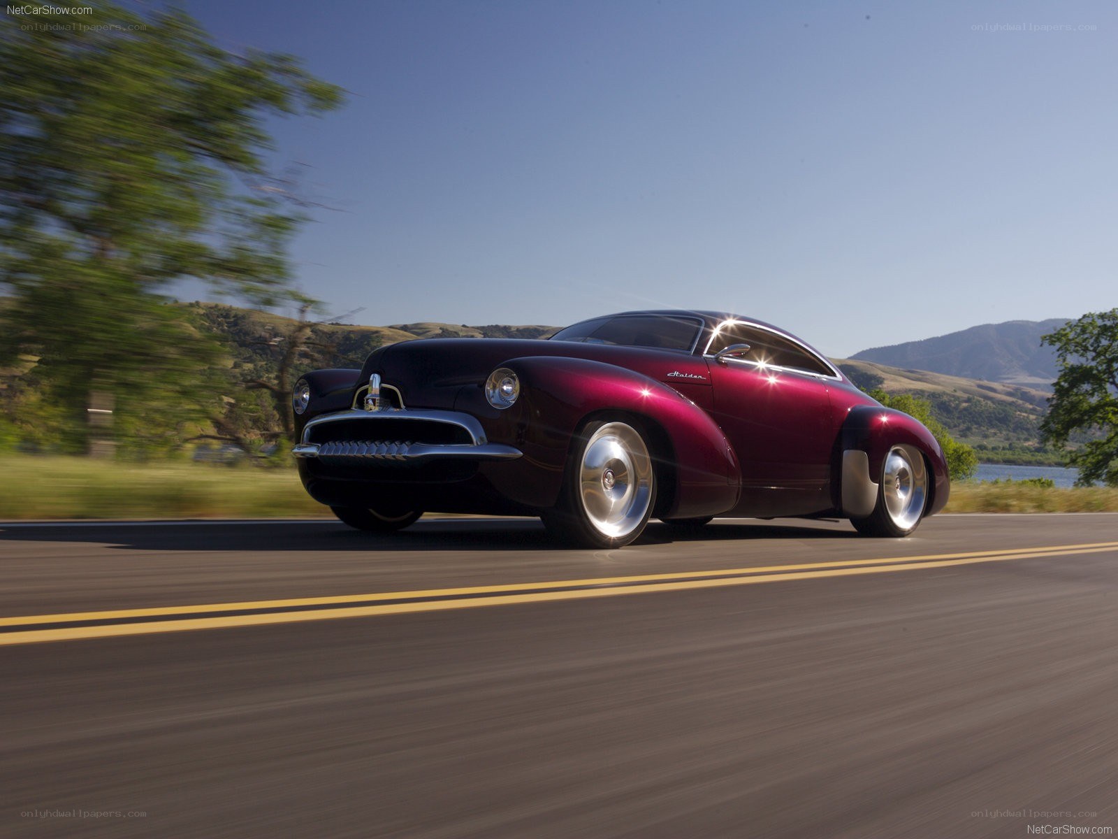 maroon classic car on road