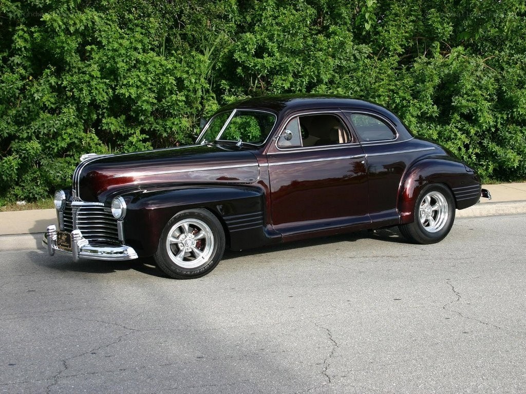 Maroon classic car on street