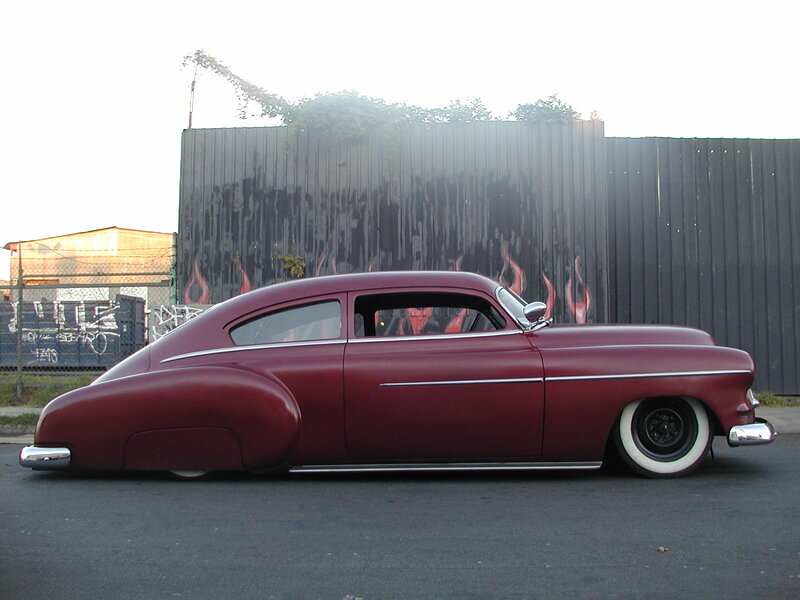 maroon classic car with flames