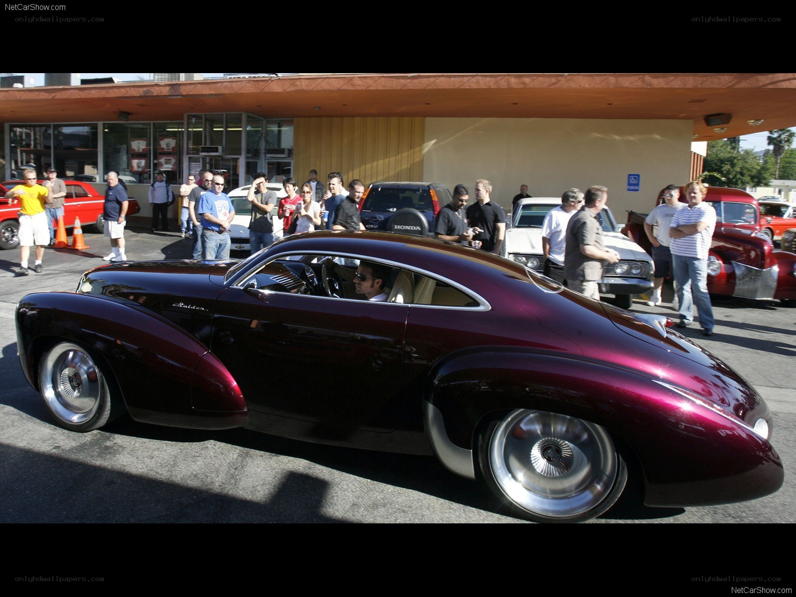 Maroon custom car at a show