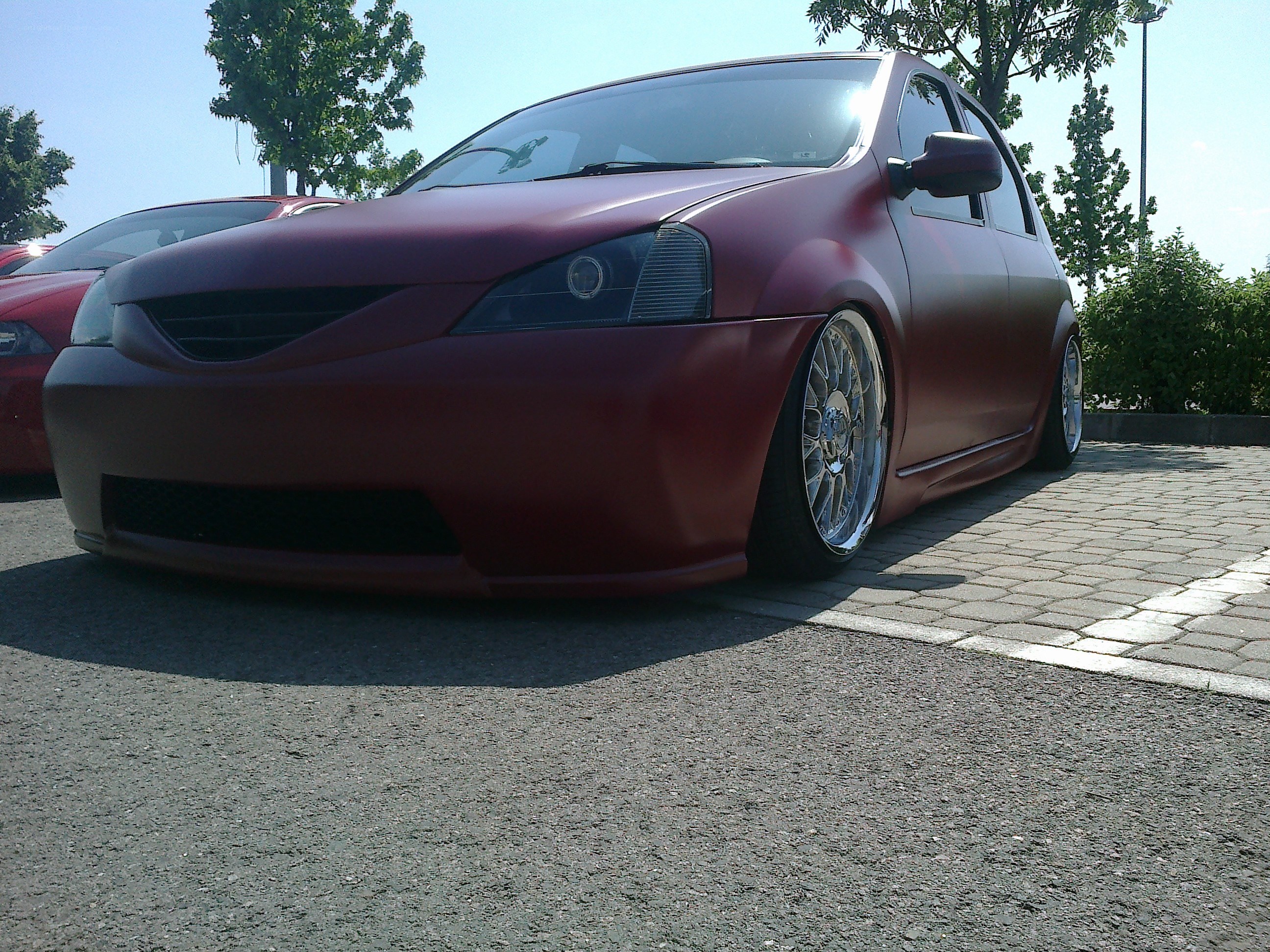 maroon custom car in parking lot