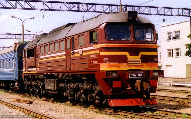 Maroon diesel locomotive on tracks