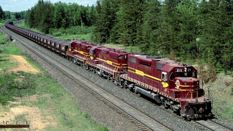 Maroon freight train in forest