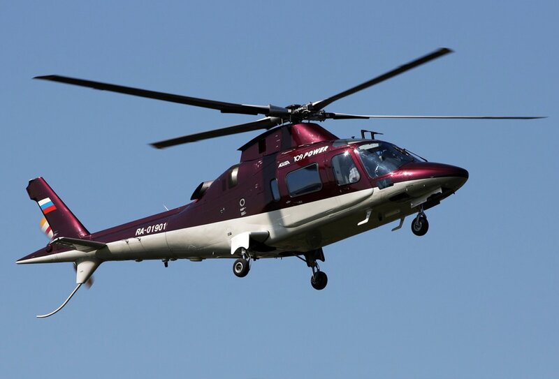 Maroon helicopter in flight