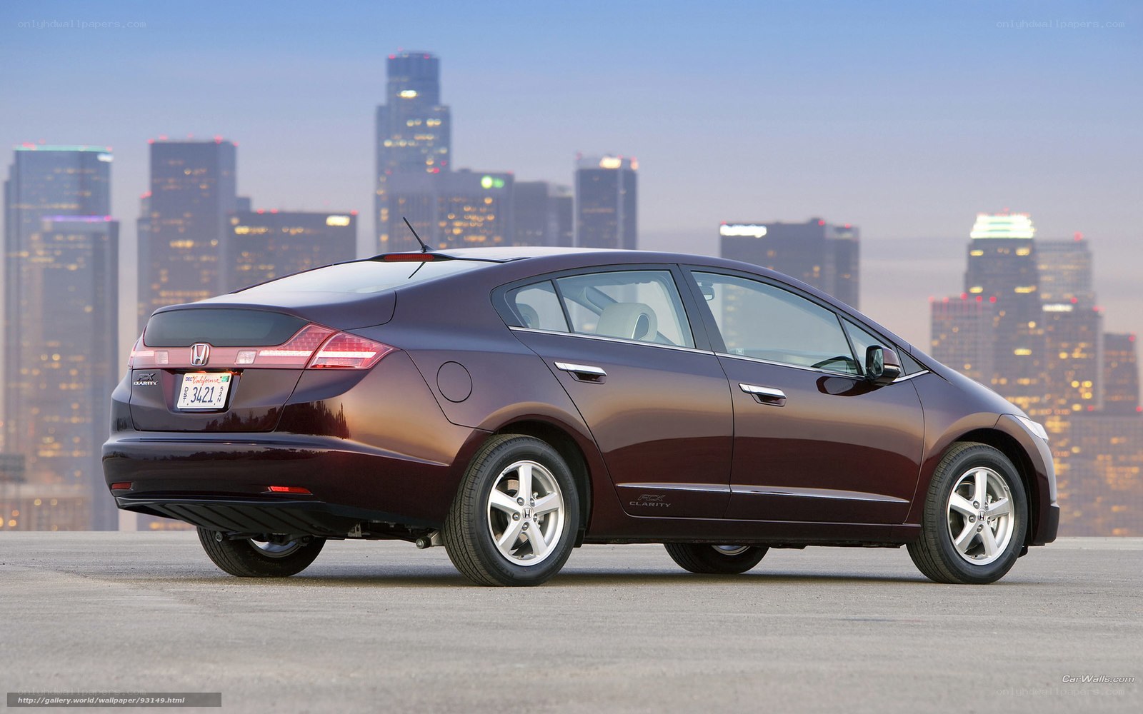 Maroon Honda Insight in city