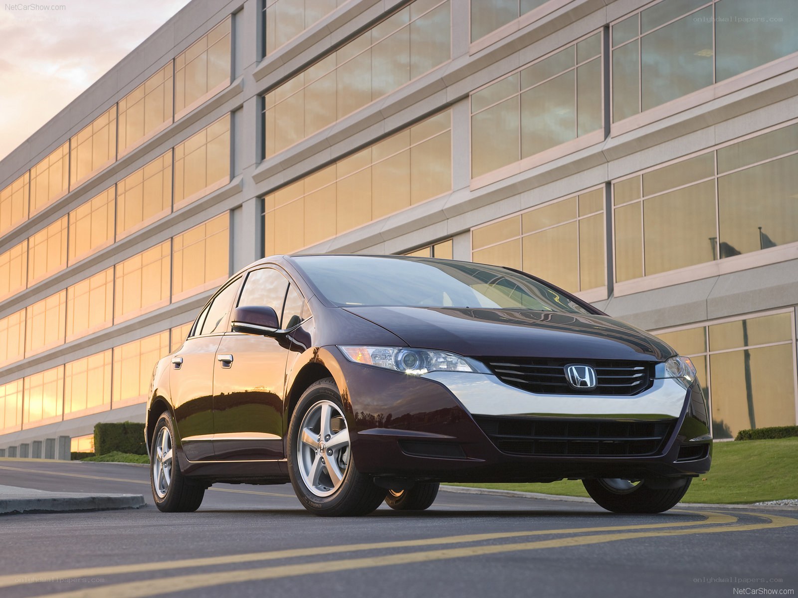 Maroon Honda Insight parked outside