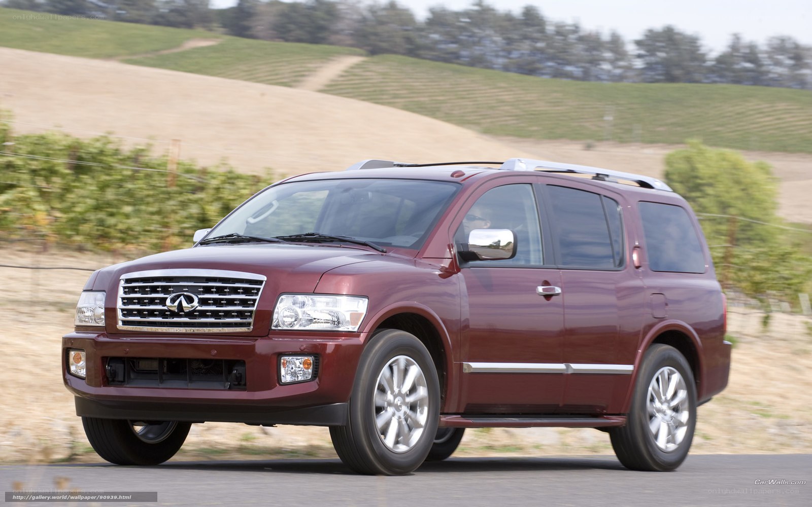 Maroon Infiniti QX56 driving on road