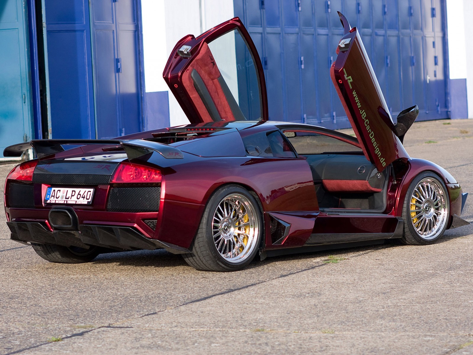 Maroon Lamborghini with doors open