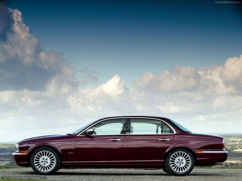 Maroon luxury sedan on a hill
