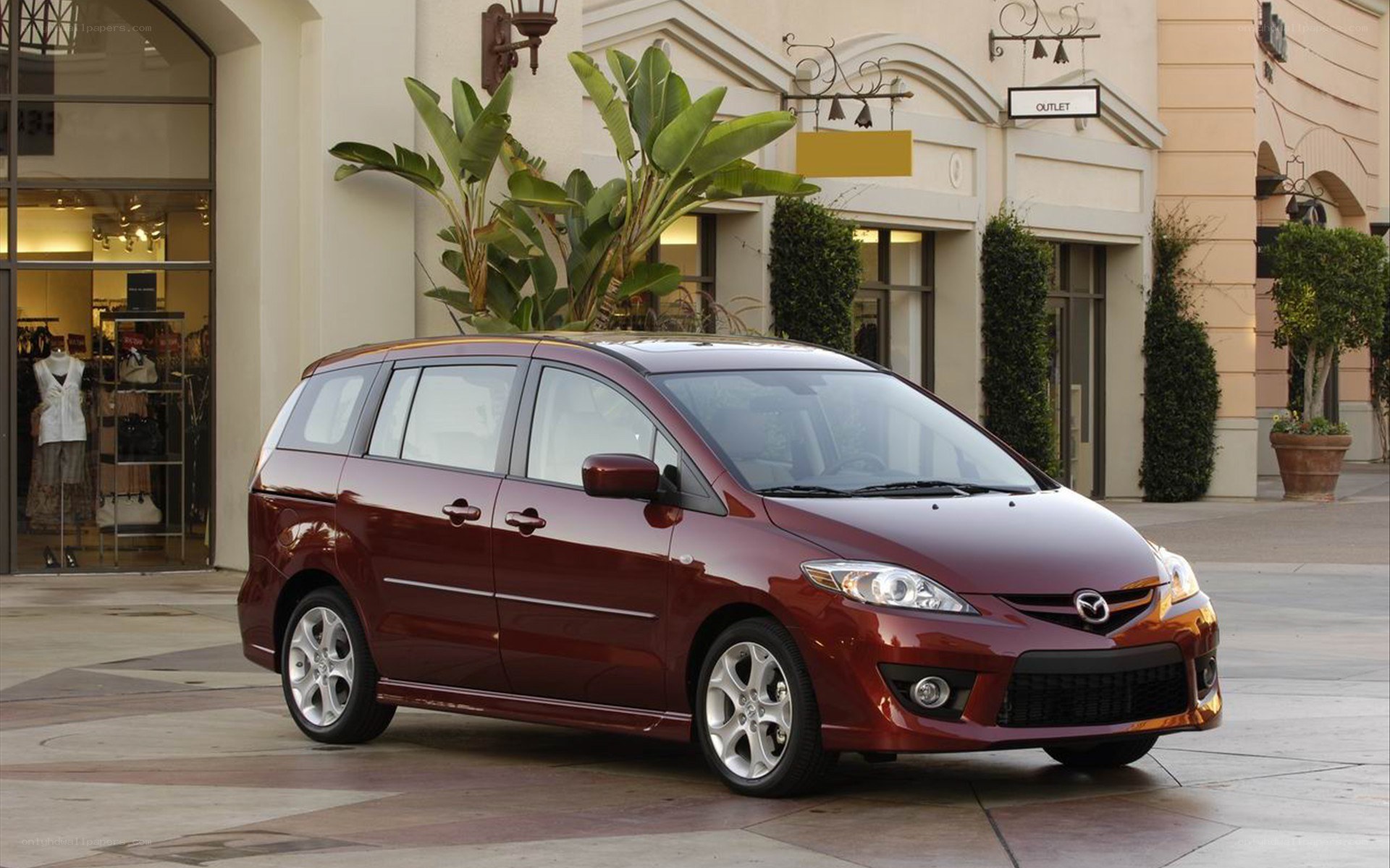 Maroon Mazda5 minivan in shopping area